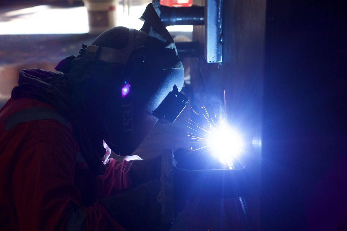 welder in workshop welding sparks fabrication